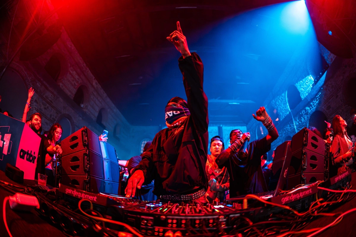 DJ booth under red and blue light at the Travis Scott club night, Tersane Grand Factory
